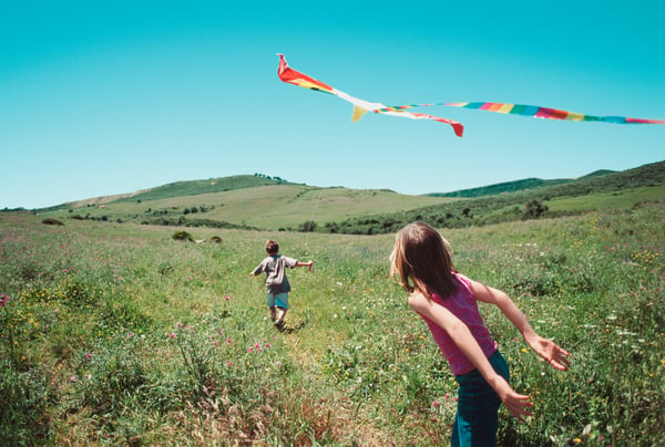 kids-playing-with-kite-gettyimages-522904060.jpg