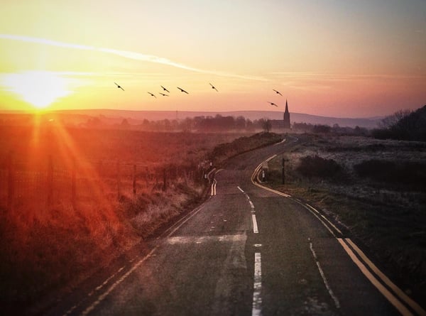 sunset-over-road-gettyimages-559166721.jpg