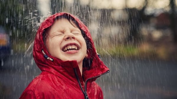 Boy smiling rain